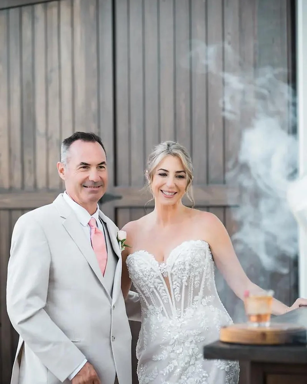 A bride and groom with a smoked old fashioned at the WinterBrooke bar