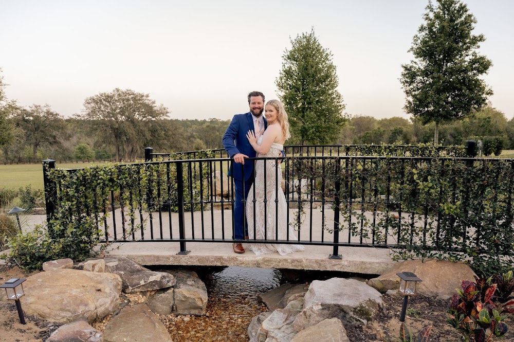 Sterling Event Center Tuscan-style architecture with stone bridge and Italian cypress trees